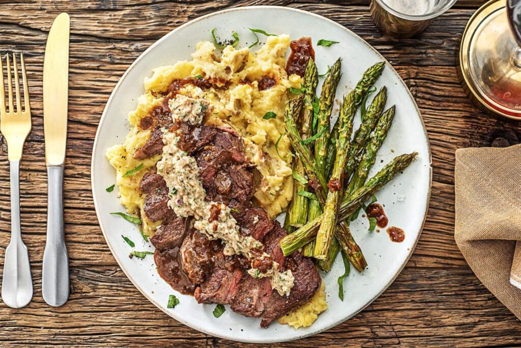 New York Strip Steak with Truffle Butter — over mashed potatoes and roasted asparagus